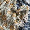 throw blanket - flowers + braided poms by creative co-op
